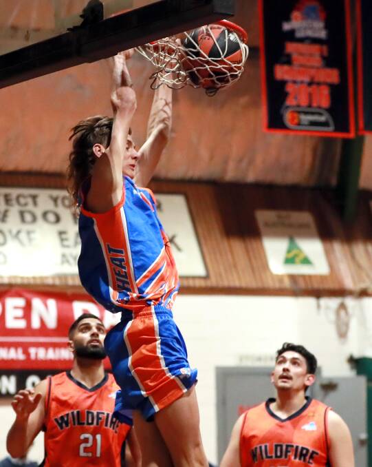 SLAM DUNK: Wagga Heat's Charlie McCormack makes his presence felt in the loss to Camden Valley at Bolton Park Stadium on Saturday night. Picture: Les Smith