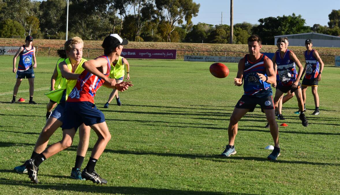 HARD YARDS: Turvey Park coach Truman Carroll working with the club's younger players during pre-season training at Maher Oval earlier in the year. Picture: Courtney Rees