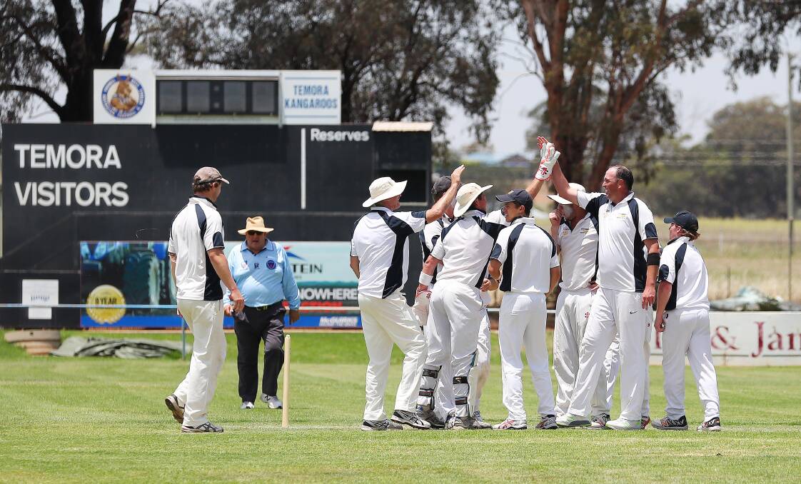 Cootamundra players celebrate a wicket in a 2017 O'Farrell Cup match against Temora at Nixon Park.