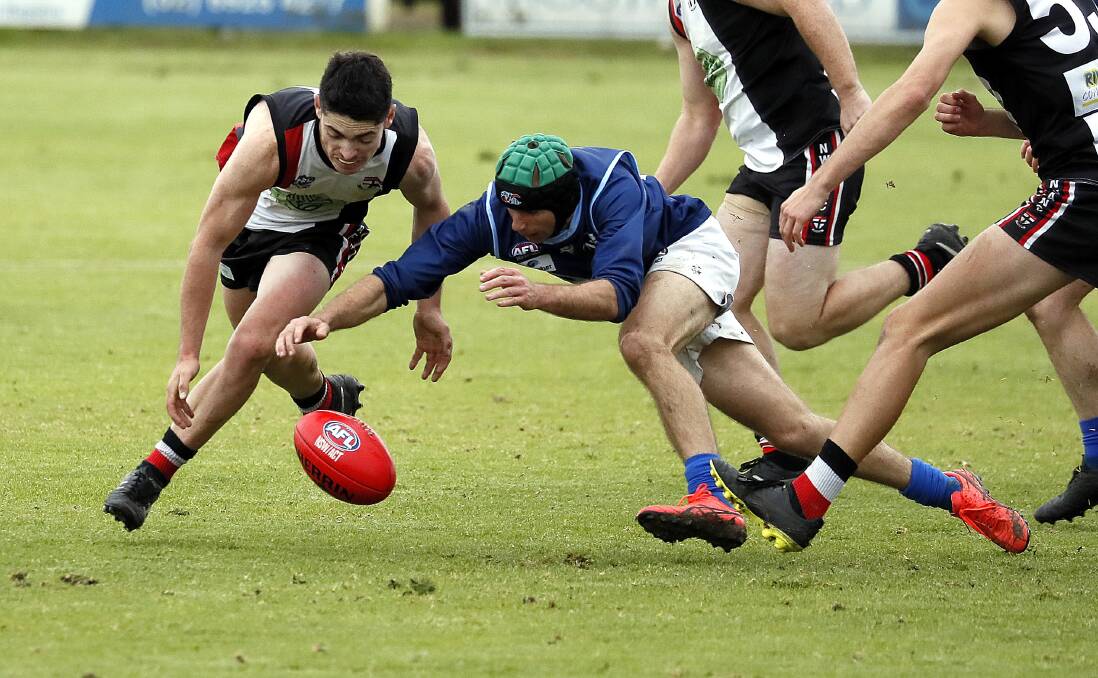 SET TO POUNCE: North Wagga's Kane Flack competes with Barellan's Dean Schmetzer in the Farrer League game at McPherson Oval on Saturday. Picture: Les Smith