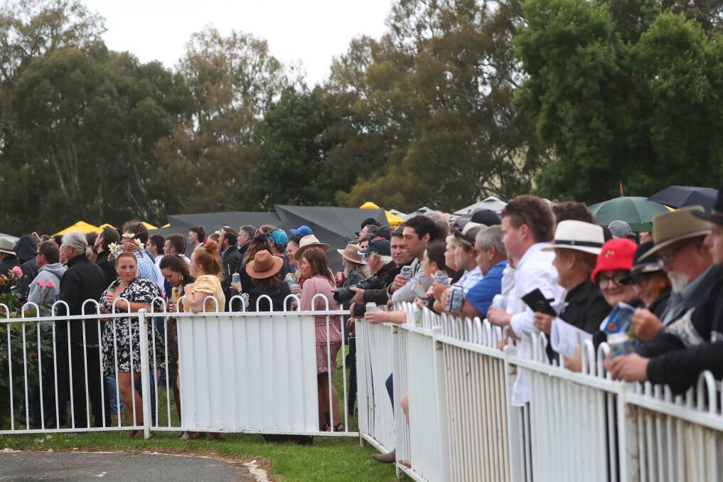 The crowd lined up to watch the Snake Gully Cup at Gundagai on Friday.