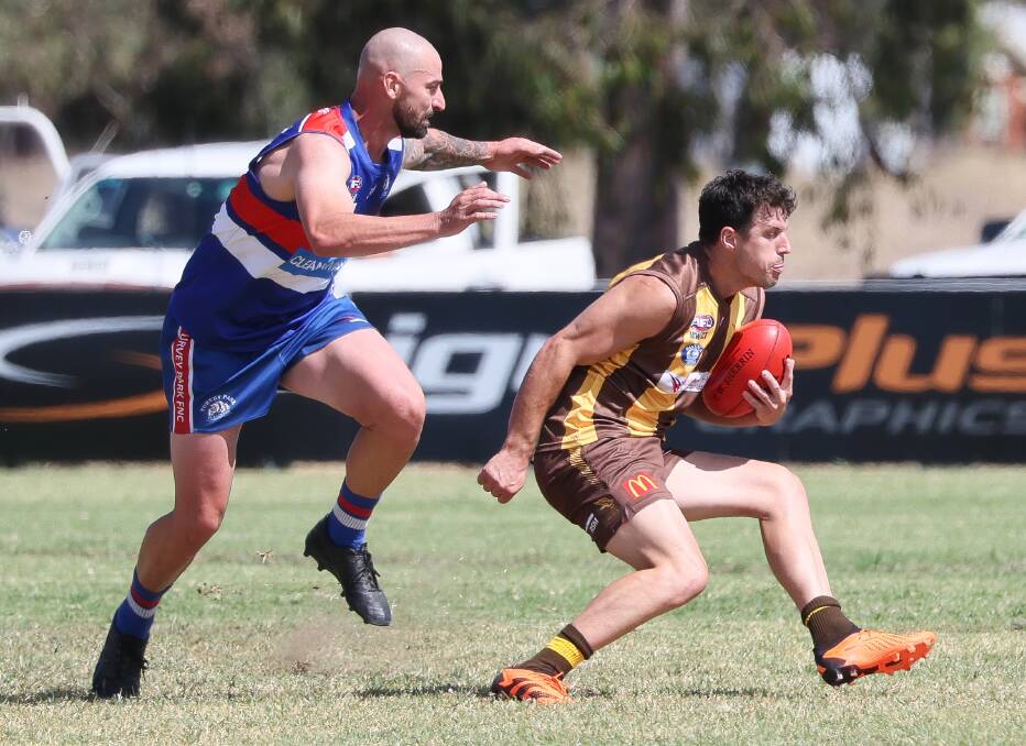 New East Wagga-Kooringal coach Jake Barrett looks to spin away from Turvey Park defender Josh Ashcroft in the trial game at Gumly Oval on Saturday. Picture by Les Smith