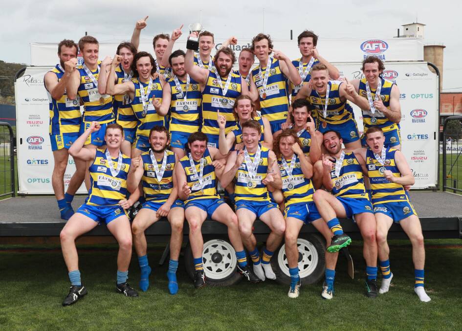HAPPY DAYS: Mangoplah-Cookardinia United-Eastlakes celebrate their reserve grade premiership win at Robertson Oval on Saturday. Picture: Les Smith