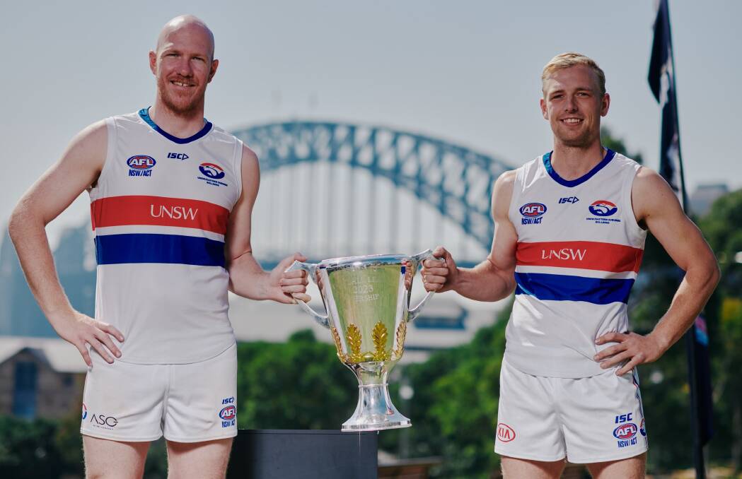 New Marrar recruits and good mates Kieran Emery and Jake Brown with the AFL premiership cup as part of a promotional photo shoot for AFL Sydney. Picture by AFL Sydney