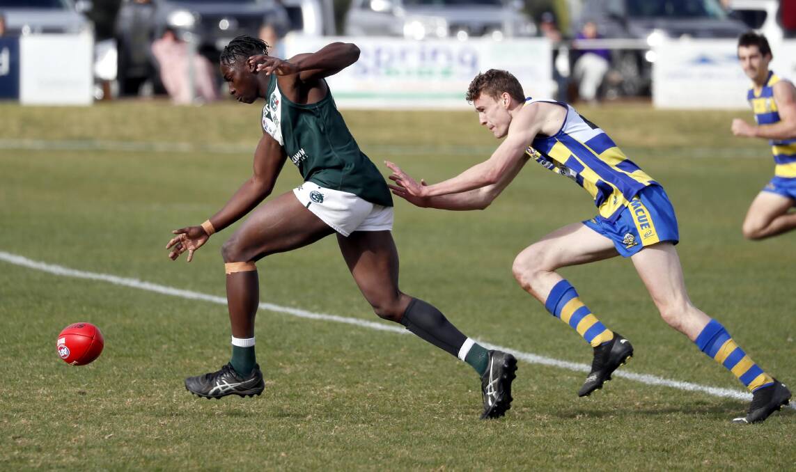 IN PURSUIT: Coolamon's Gerard Okerenyang tries to get away from Mangoplah-CUE's James Scott at Kindra Park on Sunday. Picture: Les Smith