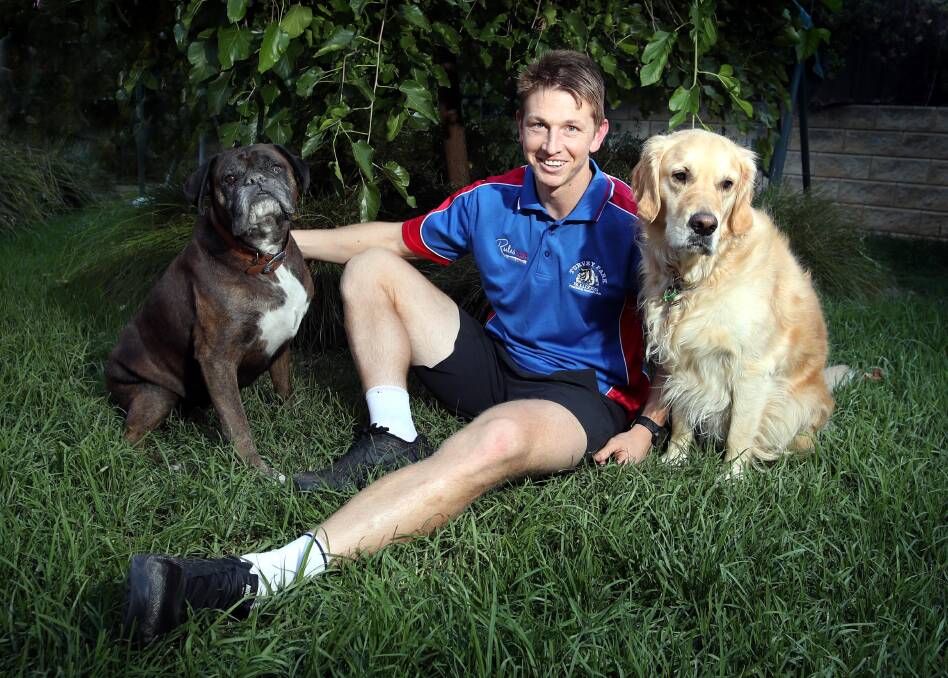 HOME, SWEET HOME: Nathan Byrne relaxes at home on Thursday with dogs Mac and Tex ahead of his first game for Turvey Park in more than a decade on Saturday.
Picture: Les Smith