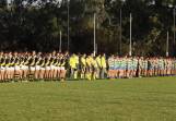 Wagga Tigers and Mangoplah-Cookardinia United-Eastlakes observe a minute's silence before this year's Good Friday fixture. Picture by Les Smith