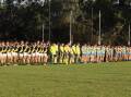 Wagga Tigers and Mangoplah-Cookardinia United-Eastlakes observe a minute's silence before this year's Good Friday fixture. Picture by Les Smith