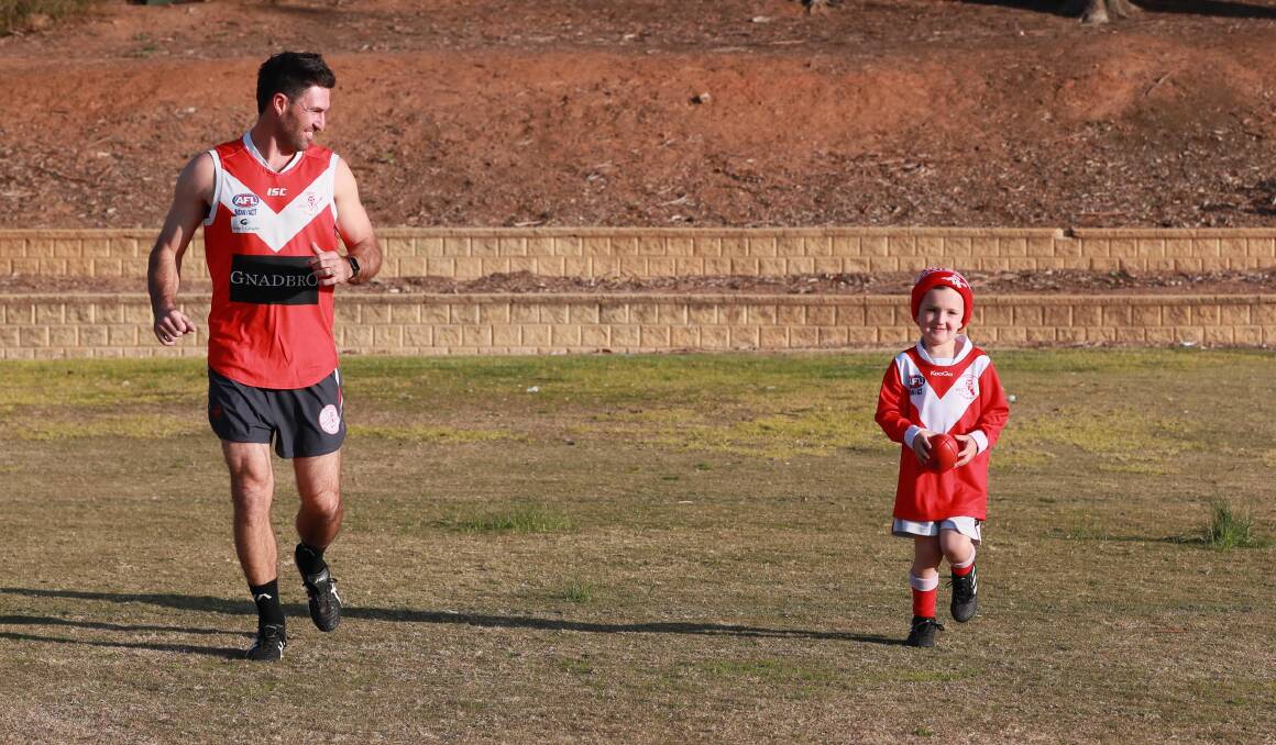 Collingullie-Glenfield Park footballer Ben Absolum with five-year-old Auskicker son Mason get some training in at Jubilee Park on Wednesday. Picture: Les Smith