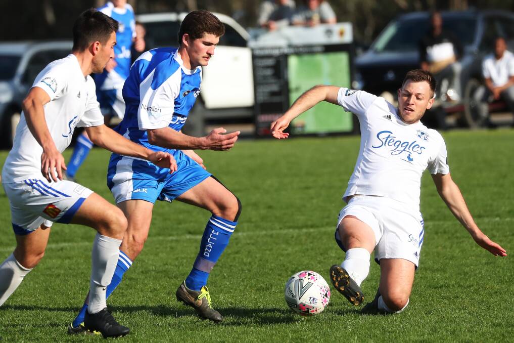 GOTCHA: Hanwood's Demetrio Torino slides in to tackle Tolland captain Jaiden Watson in the Pascoe Cup encounter at Rawlings Park on Sunday. Picture: Emma Hillier