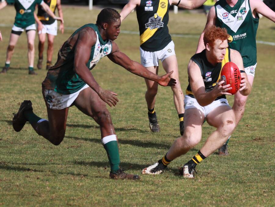EVASIVE: Wagga Tigers coach Murray Stephenson gets away from Coolamon's Gerard Okerenyang at Kindra Park on Sunday. Picture: Les Smith