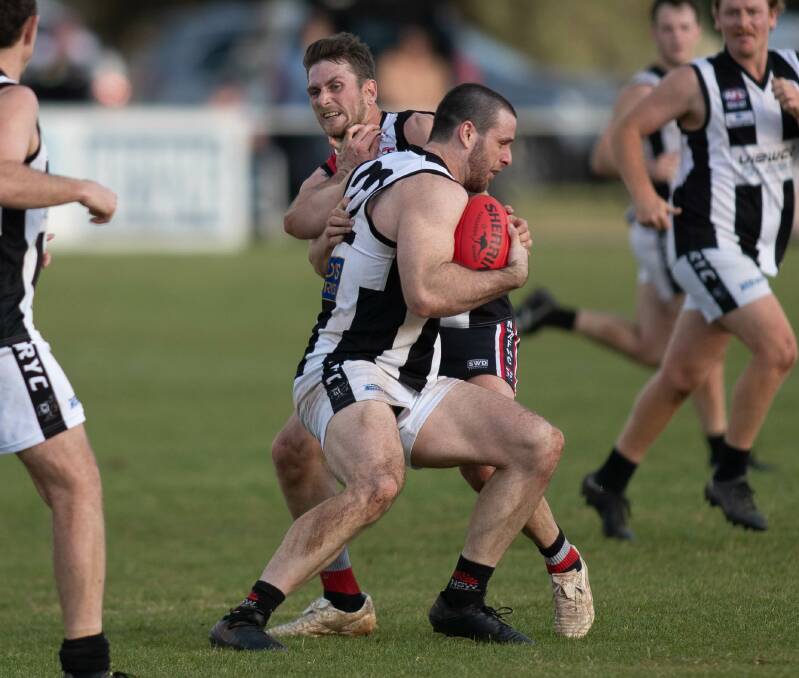 The Rock-Yerong Creek's Riley Budd attempts to shrug off North Wagga's Matt Parks in Sunday's elimination final at Langtry Oval. Picture by Madeline Begley