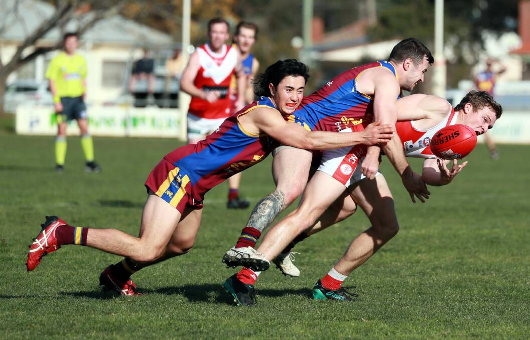 GANG TACKLE: GGGM's Jack Sase and Michael Rothnie drive Collingullie-GP's Josh Gunning to the ground at Ganmain on Sunday. Picture: Les Smith