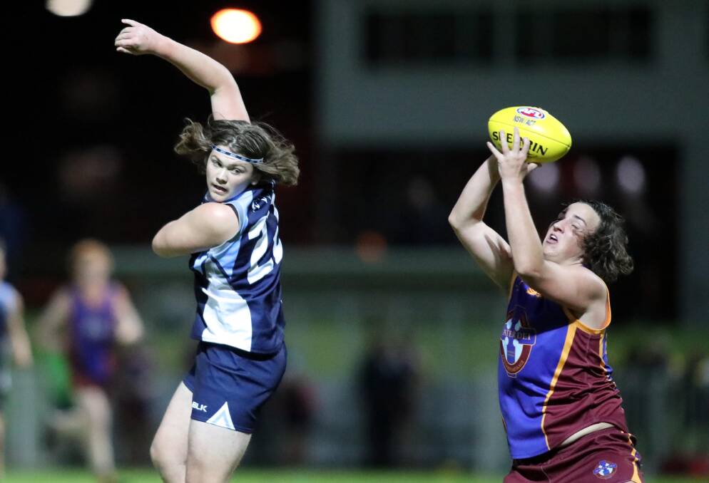 ON SONG: Mater Dei Catholic College's Kolby McMahon marks against Wagga High School's Zac Whyte in the Carroll Cup semi-final at Robertson Oval on Wednesday
night. Picture: Les Smith