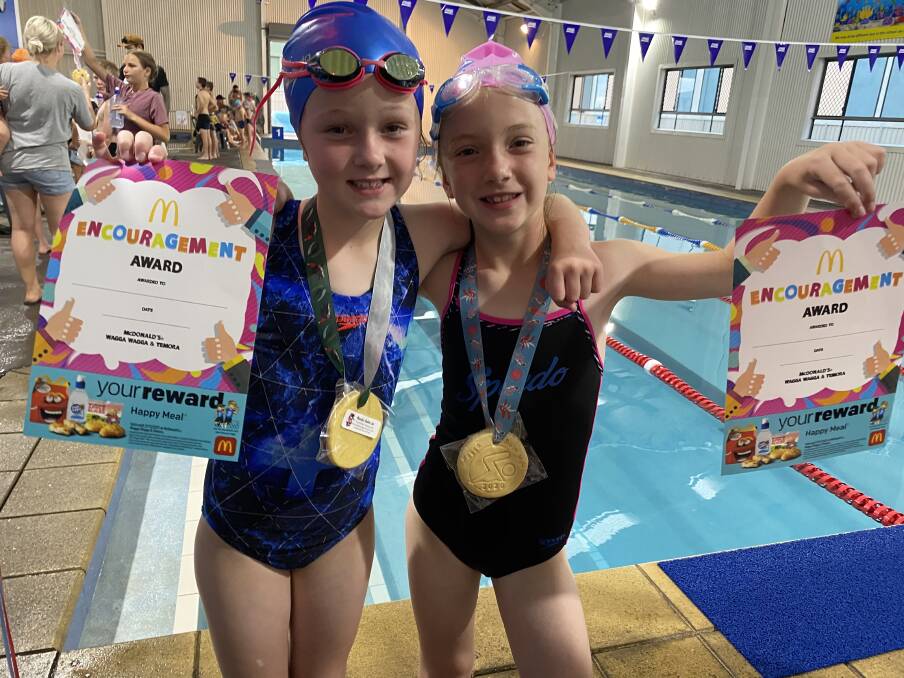 TOP PERFORMERS: Isabella Firman and Millie Warden show off their awards from the Wagga Swim Hub Christmas Carnival on Tuesday evening.