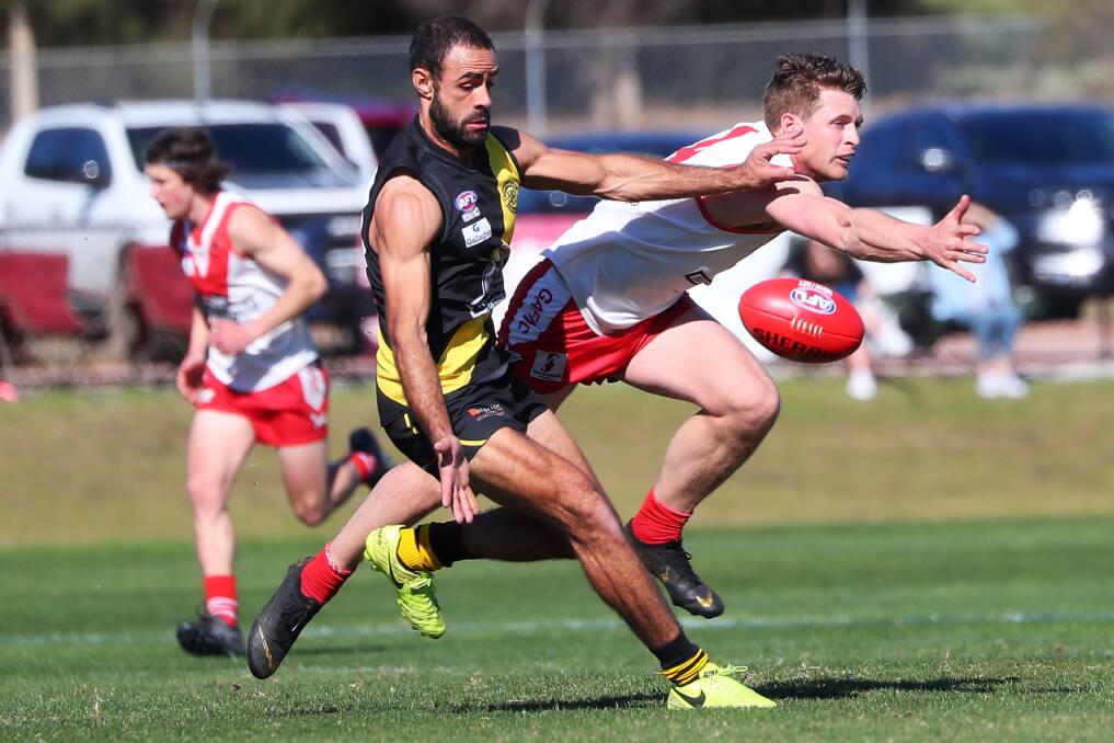 GREAT MATCH-UP: Wagga Tigers forward Jesse Manton and Griffith defender James Toscan do battle during the finals series. Picture: Emma Hillier