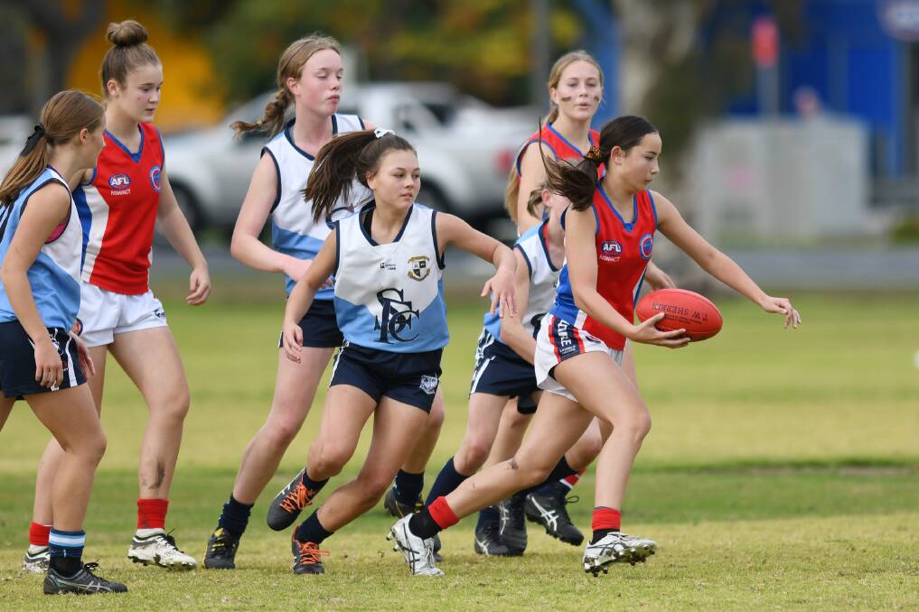 ON THE RUN: Kildare Catholic College's Anna Sase looks to get her kick away in the game against Leeton's St Francis College at Bolton Park on Wednesday.
