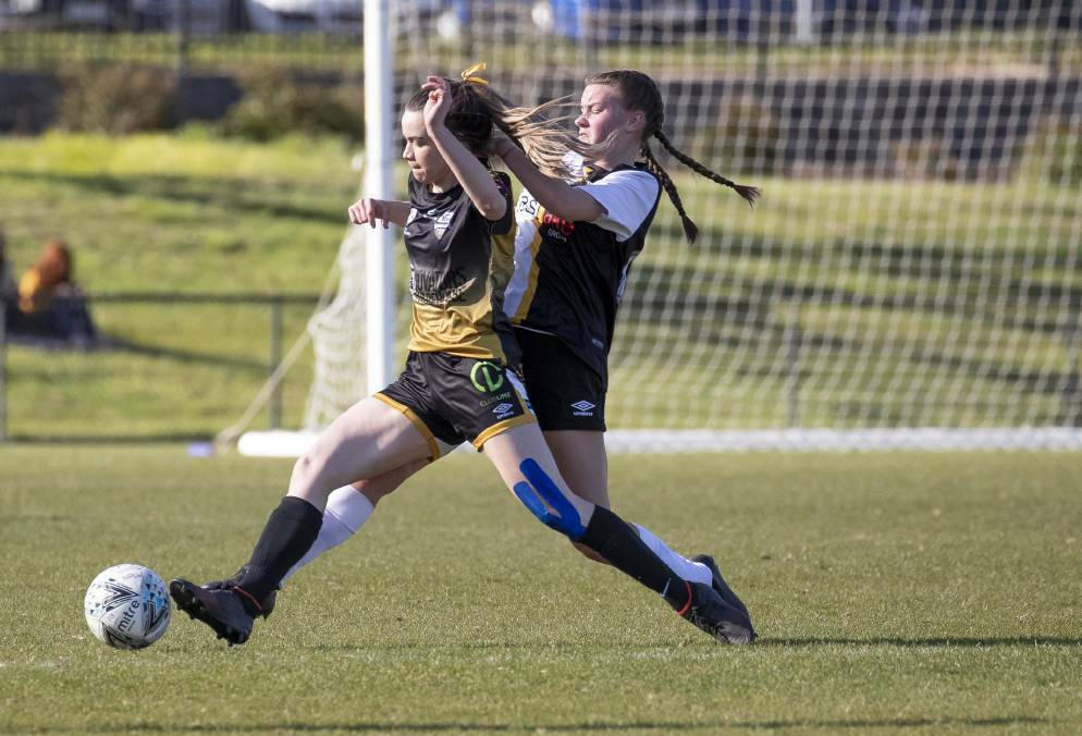 STRONG CHALLENGE: Wagga City Wanderers' Olivia Moore competes with Gungahlin United's Jade Brown in Canberra on Sunday. Picture: Sitthixay Ditthavong