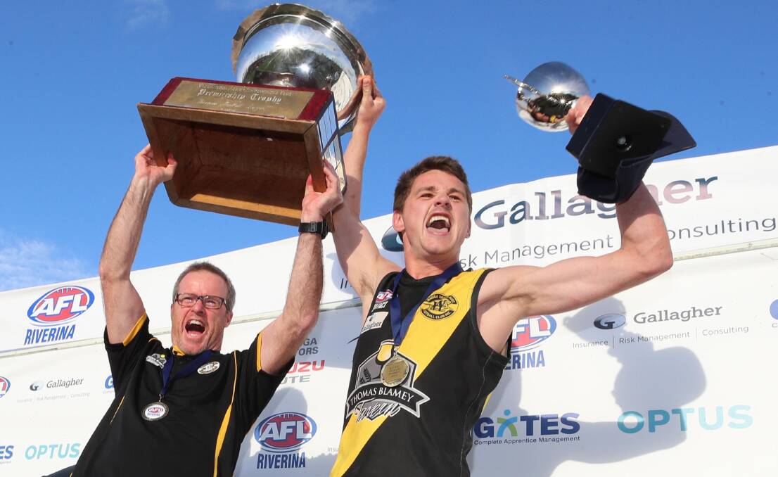 Troy Maiden and Nick Ryan lift the premiership trophy aloft.
