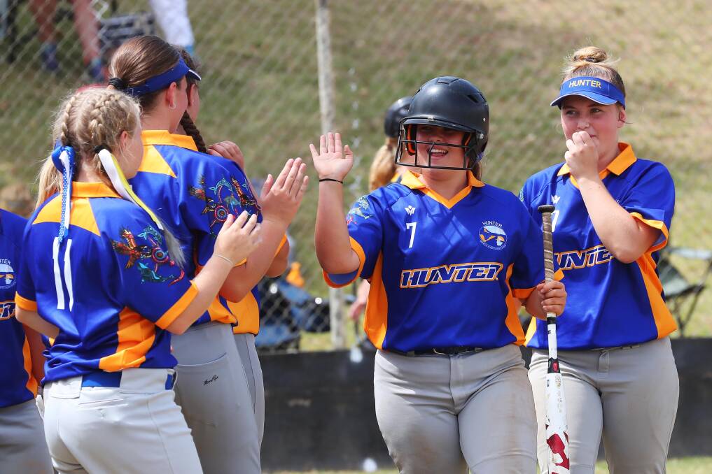 HIGH FIVE: Emily Gordan celebrates a home run with her Hunter teammates at the opening day of the NSWCHSSA Girls Secondary Softball Championships in Wagga. Picture: Emma Hillier