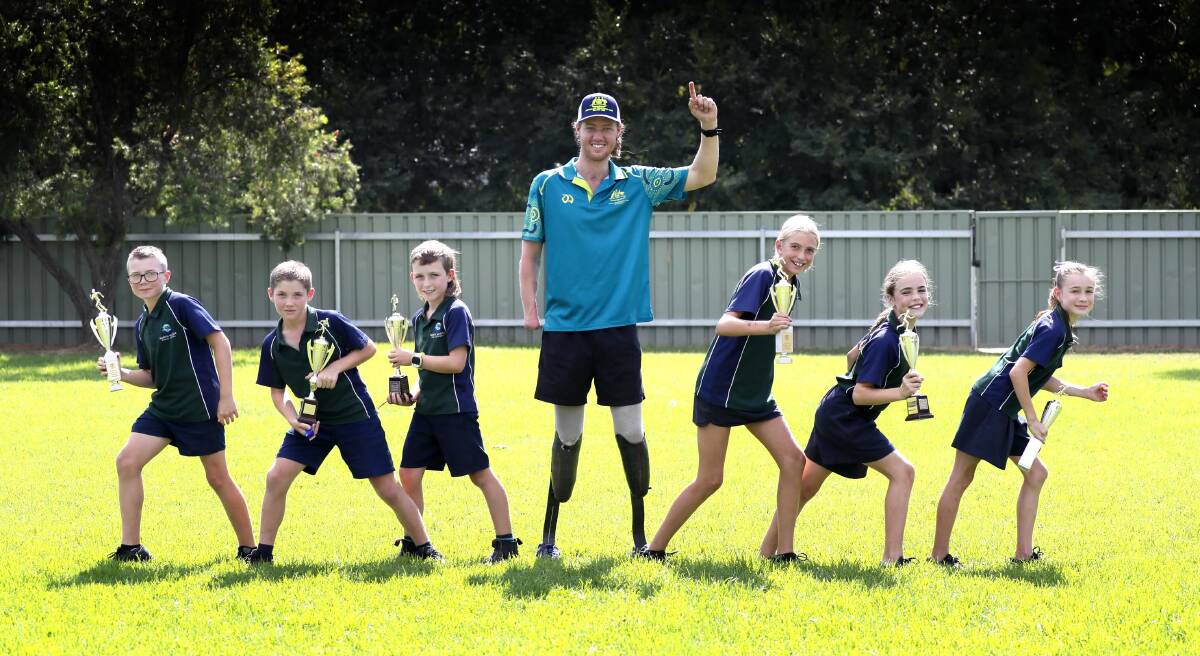 NEXT STEP: Josh Hanlon at North Wagga Public School last month with athletics age champions Ashton Feary, 11, Toby Campbell, 10, Joey Rake, 9, Isabella Baulch, 11, Harper Hann, 10 and Ivy Chobdzynski. Picture: Les Smith
