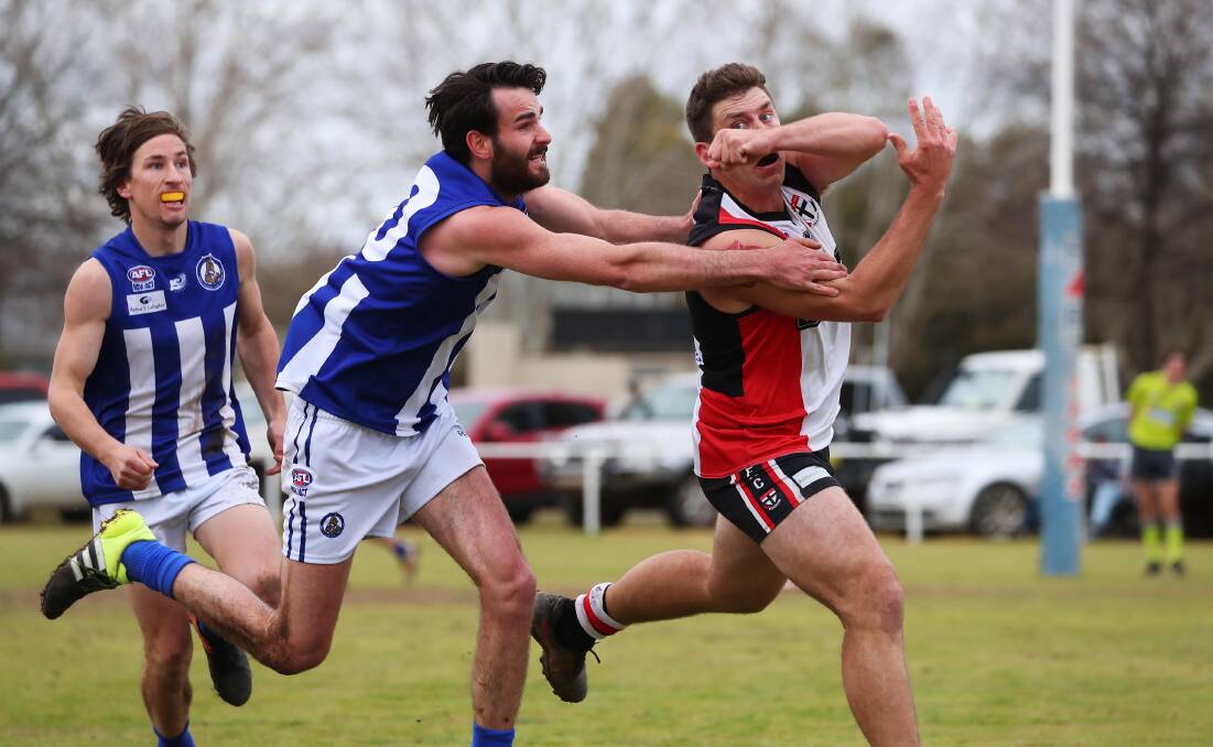 PRESSURE: Jack Irvine (middle) in action against North Wagga late in the season. Picture: Emma Hillier
