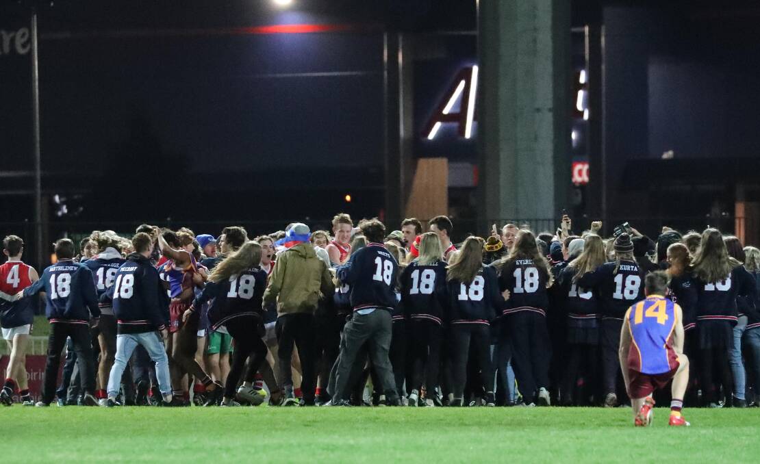 Crowds swarm onto Robertson Oval after the 2018 Carroll Cup decider.
