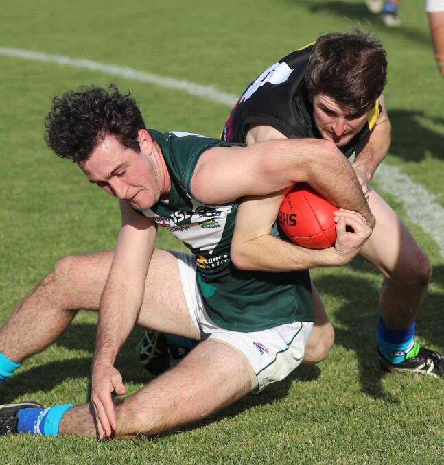 Coolamon's Ryan Allen battles for the football with Wagga Tigers' Nathan Cooke at Kindra Park last month. Picture: Les Smith