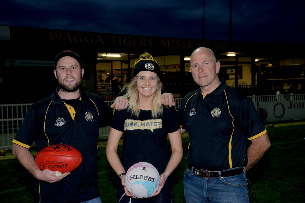 GOOD CAUSE: Wagga Tigers' footballer Nick Munro, netballer Kate Roberts and president Anthony Lyons at Robertson Oval. Picture: MMS Media
