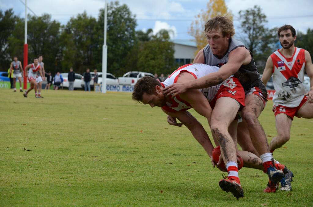 UNDER THE PUMP: Griffith's Heath Northey is swamped by Collingullie-Glenfield Park's Matt Klemke at Exies Oval on Saturday. Picture: Liam Warren