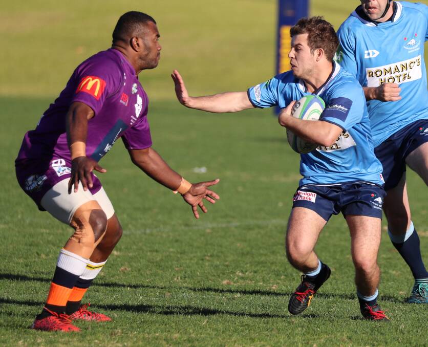 PALM: Waratahs' George Mallat gives Leeton's Faasolo Seve the fend off in the Southern Inland rugby game last Saturday. Picture: Les Smith
