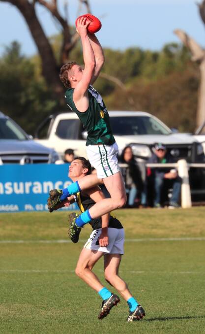 HIGH FLYER: Coolamon defender Josh Buchanan takes a big mark on Nick Ryan's shoulder in the Riverina League game at Kindra Park on Sunday. Picture: Les Smith