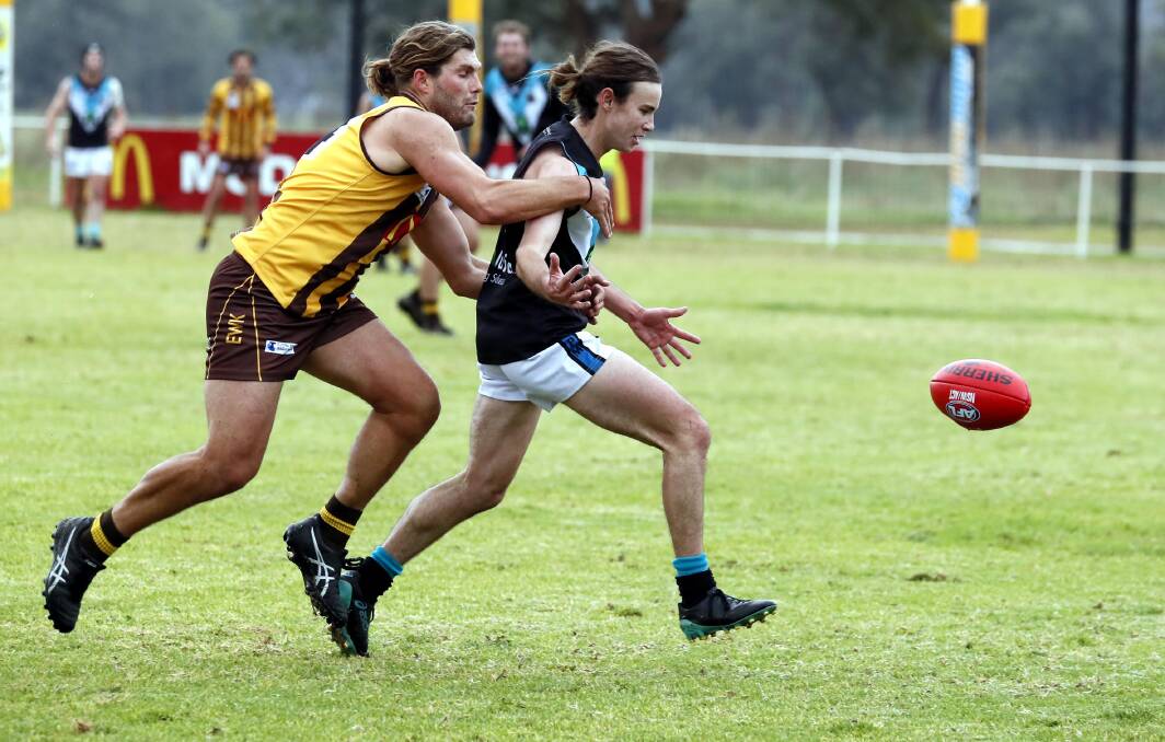BIG ASPIRATIONS: Northern Jets' Henry Grinter leads East Wagga-Kooringal's Kade Rowbotham in the chase to the ball in a Farrer League game last Saturday week. Both clubs are applying to join the premier league next year. Picture: Les Smith