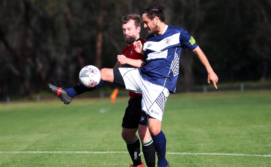 CLOSE CALL: Young's Bradley Galvin and Lake Albert's Justin Curran compete in the Pascoe Cup encounter at Rawlings Park on Sunday. Picture: Emma Hillier