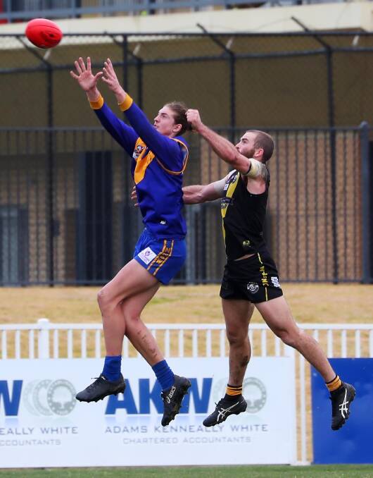 STRONG: Narrandera's Macauley Smith marks in front of Wagga Tigers coach Shaun Campbell at Robertson Oval on Saturday. Picture: Emma Hillier