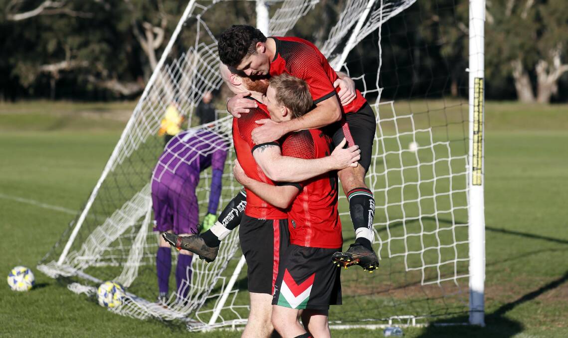 GROUP HUG: Lake Albert's Jamie Rankin, Jaiden Watson and Matt Kleine celebrate their opening goal against Wagga United at Rawlings Park on Sunday. Picture: Les Smith