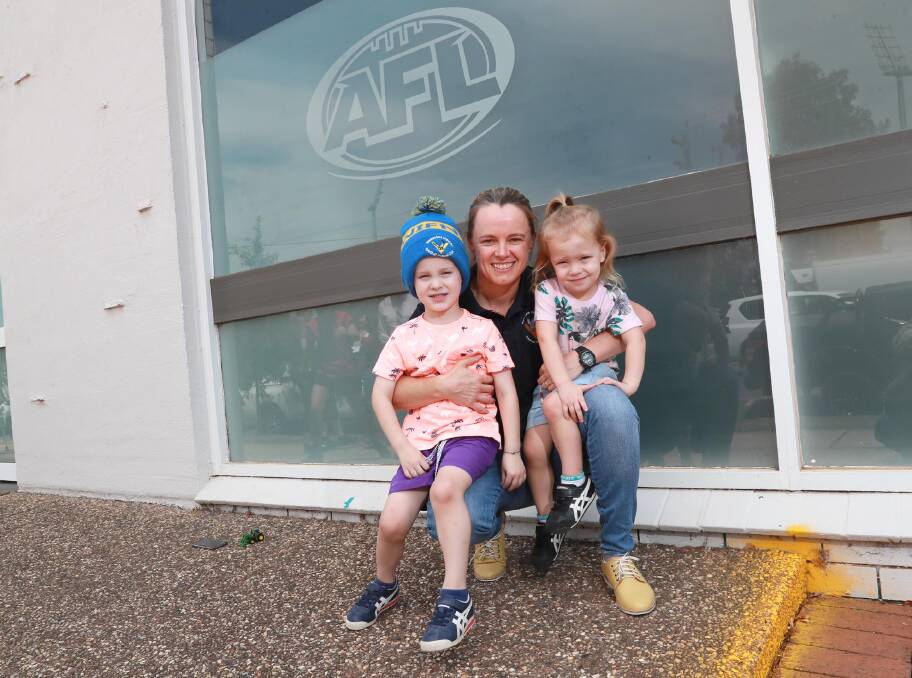 NEW BEGINNING: Julie McLean, with kids Teddy Hyland-McLean, 4, and Albie Hyland-McLean, 2, ahead of her return to football with Narrandera on Friday night. Picture: Les Smith