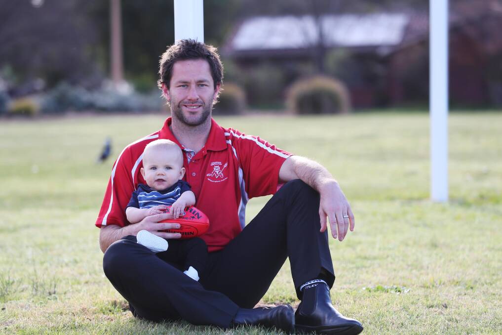 SPECIAL BOND: Collingullie-Glenfield Park forward Marc Geppert with six-month old son Hutch on Tuesday. Picture: Emma Hillier