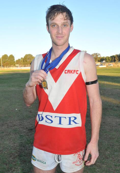 ON THE MOVE: Matt Beckmans shows off his Ron Hutchins Medal, along with his premiership medal, after Collingullie-Glenfield Park's 2014 grand final win. Picture: Laura Hardwick