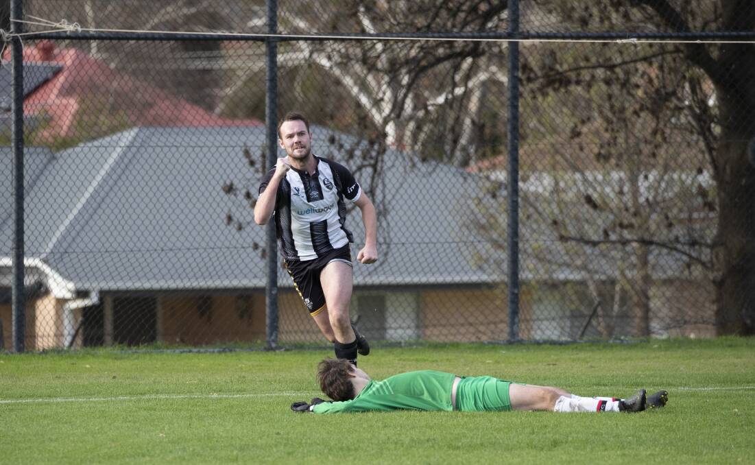 ON THE BOARD: Wagga City Wanderers' Jake Ploenges celebrates the first goal of the game as the Weston Molonglo keeper is left to wonder what could have been at Gissing Oval on Saturday. Picture: Madeline Begley