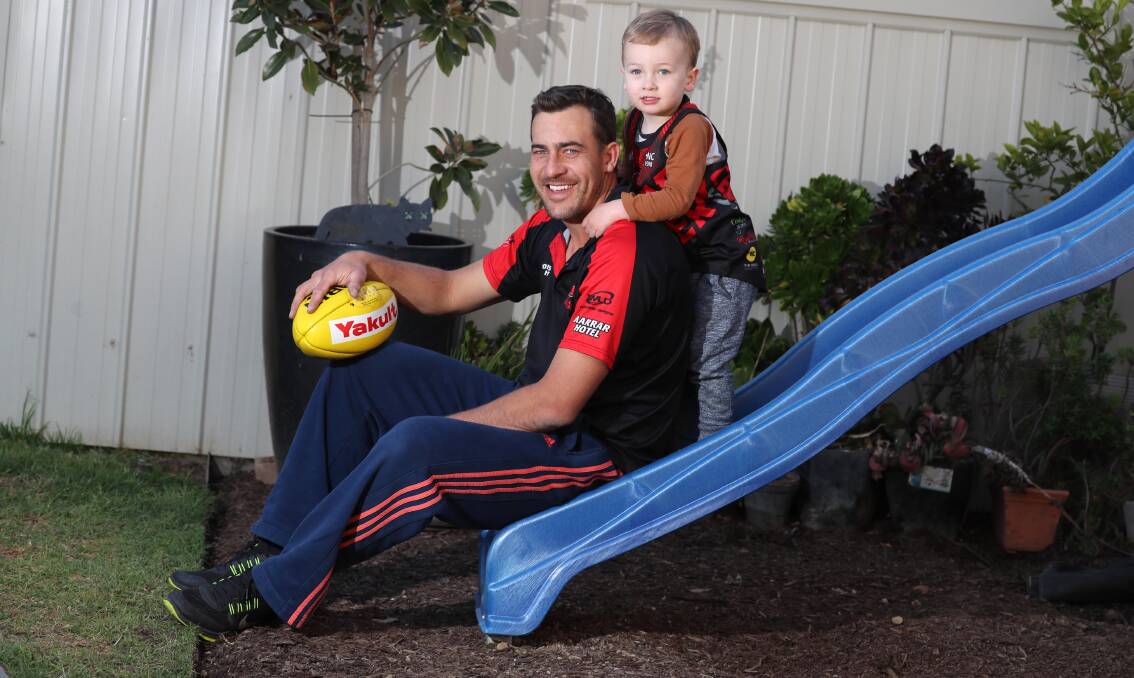 Clint Taylor with son Archie at home on Thursday. Picture: Les Smith