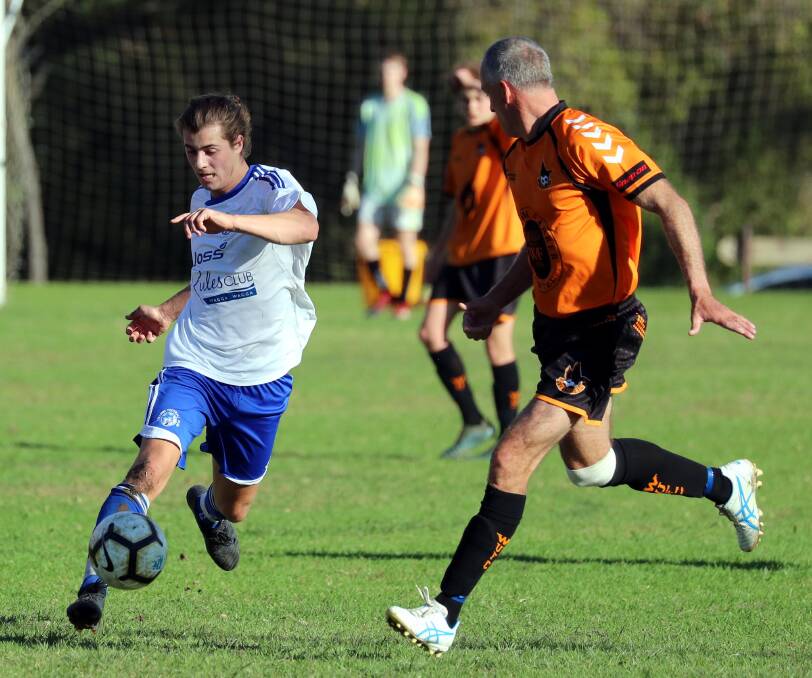 Tolland's Nick Tsipiras tries to get past Wagga United's Adrian Weir in Pascoe Cup action last Sunday. Picture: Les Smith