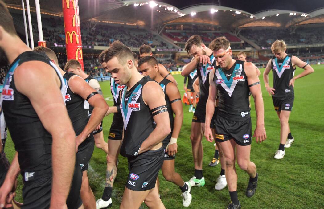 TOUGH LOSS: Dougal Howard walks off the ground with his Port Adelaide teammates on Saturday night. Picture: AAP