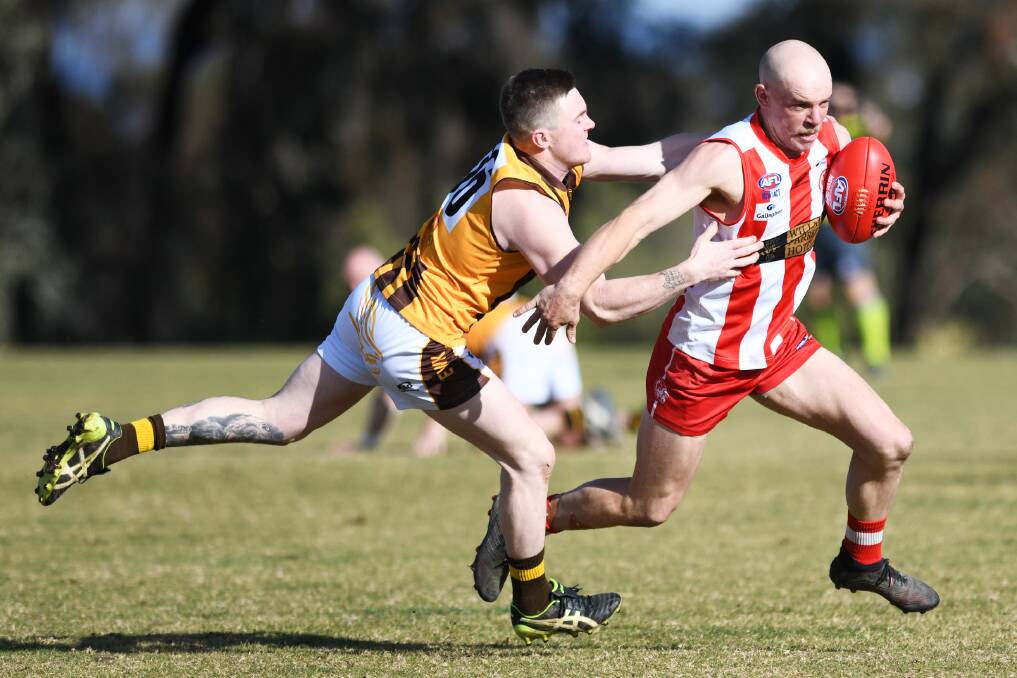 GOTCHA: East Wagga-Kooringal's Ethan Andrews attempts to tackle Charles Sturt University's Brayden Ambler in the Farrer League game at Peter Hastie Oval on Saturday. 