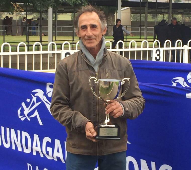 EXPERIENCED: Long-time Gundagai trainer David Blundell with the Gundagai Cup he won with Monkery. Picture: Gundagai-Adelong Race Club