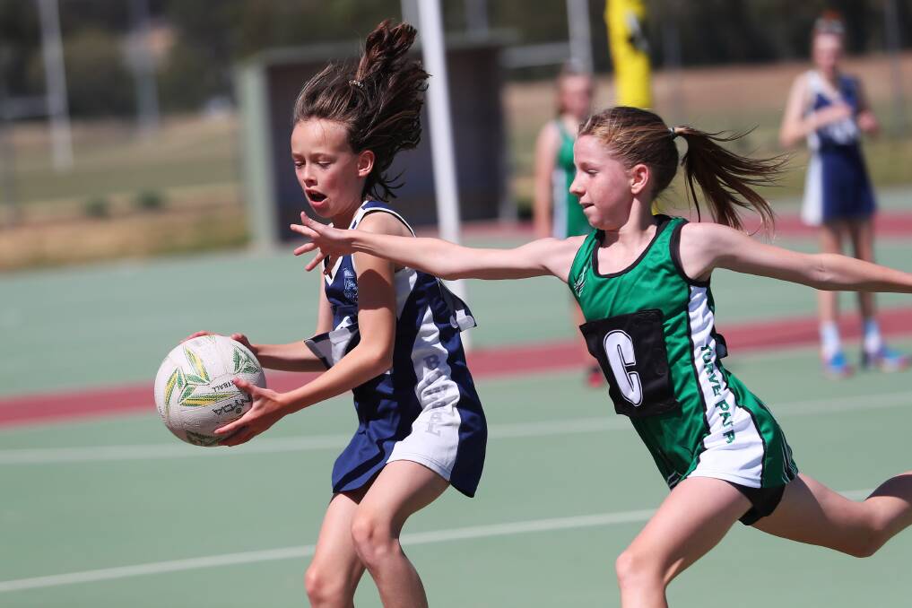 PRESSURE: Bowral Public School's Ava Buckley takes the ball ahead of Turvey Park Public School's Pippa Errington in the quarter final of the PSSA Netball Knockout at Wagga Netball Centre on Tuesday. Picture: Emma Hillier