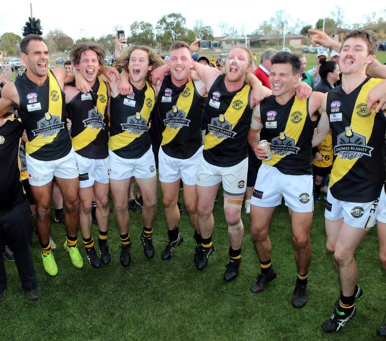 WE DID IT: Wagga Tigers players belt out the team song in the middle of Narrandera Sportsground on Saturday. Picture: Les Smith