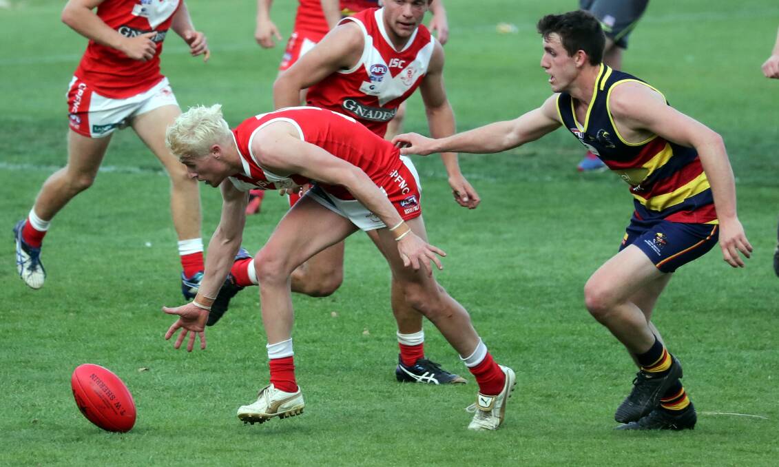 CLOSE COMPETITION: Collingullie's Steve Jolliffe and Leeton-Whitton's Tom Meline battle it out in last year's Riverina League grand final.