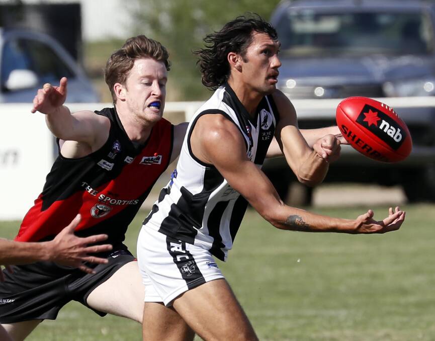 TOO GOOD: The Rock-Yerong Creek's Liam Lupton fires off a handball before Marrar's Dan O'Reilly arrives with a tackle at Langtry Oval on Saturday. Picture: Les Smith