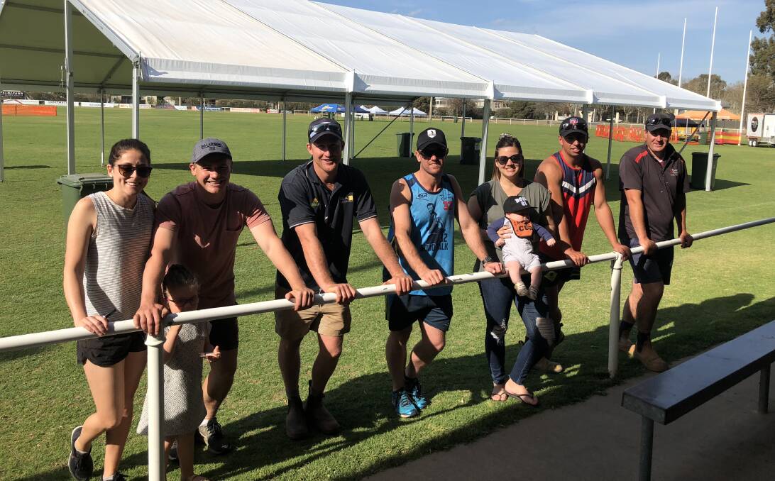 READY TO GO: Tessa Hamblin, Sienna Evans, Kirk Hamblin, Brenton Browne, Justin Evans, Kate Evans with son Easton, Ned Mortimer and Jon Curry put the finishing touches on McPherson Oval on Friday.